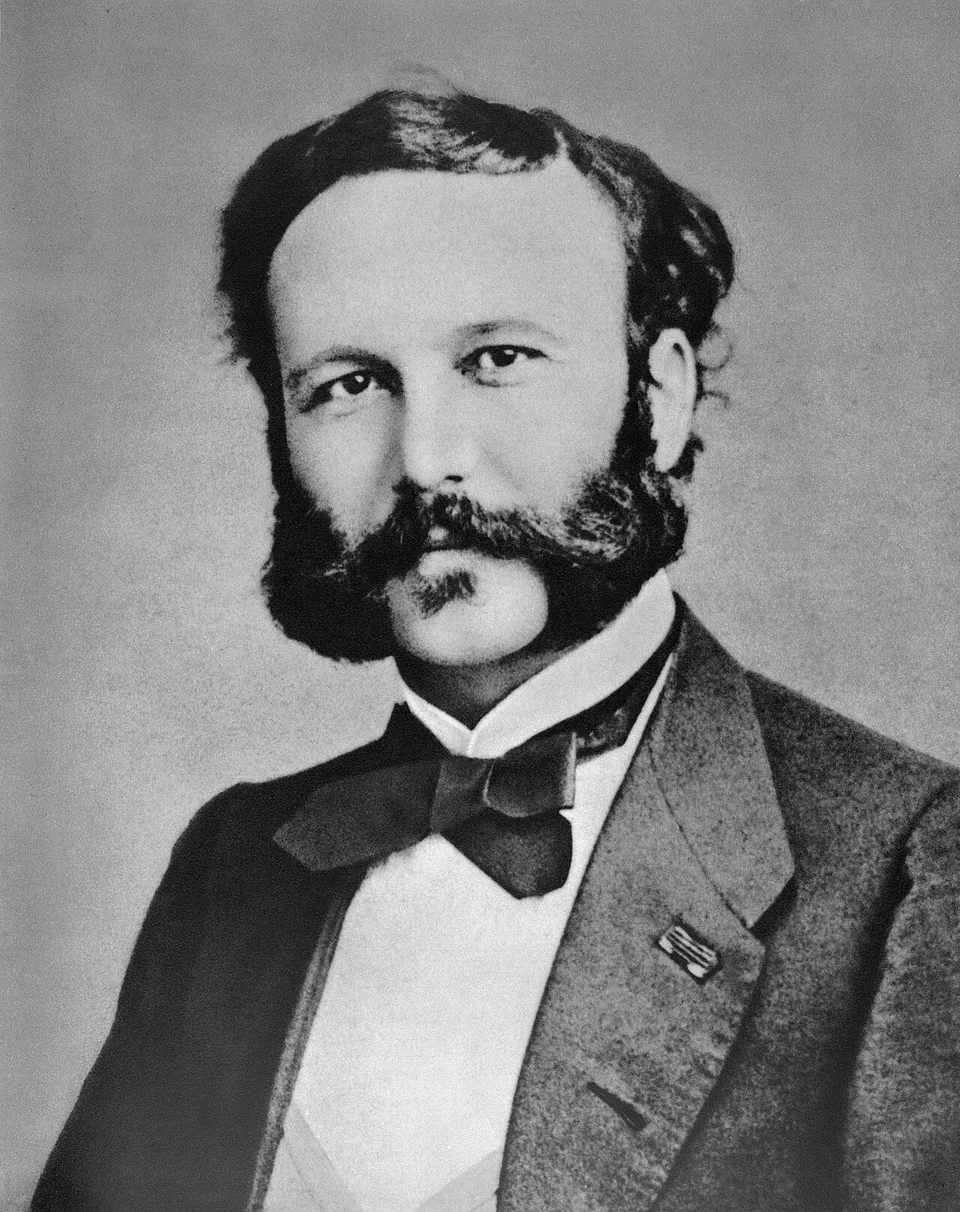 Henry Dunant jovem: barba, bigode, gravata-borboleta e casaco escuro