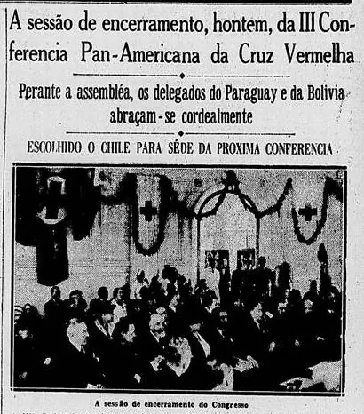 Newspaper clipping with a photograph of the closing assembly, with flags and the red cross