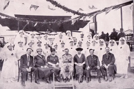 Group of nurses and guests under bunting at the foundation-stone ceremony